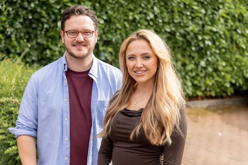 Adam Graver and Lucy Collinge, the founders of House of Marque, smiling at the camera outdoors